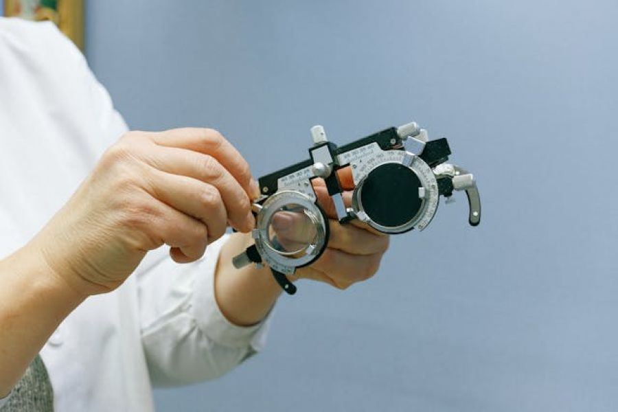 An optometrist handles equipment