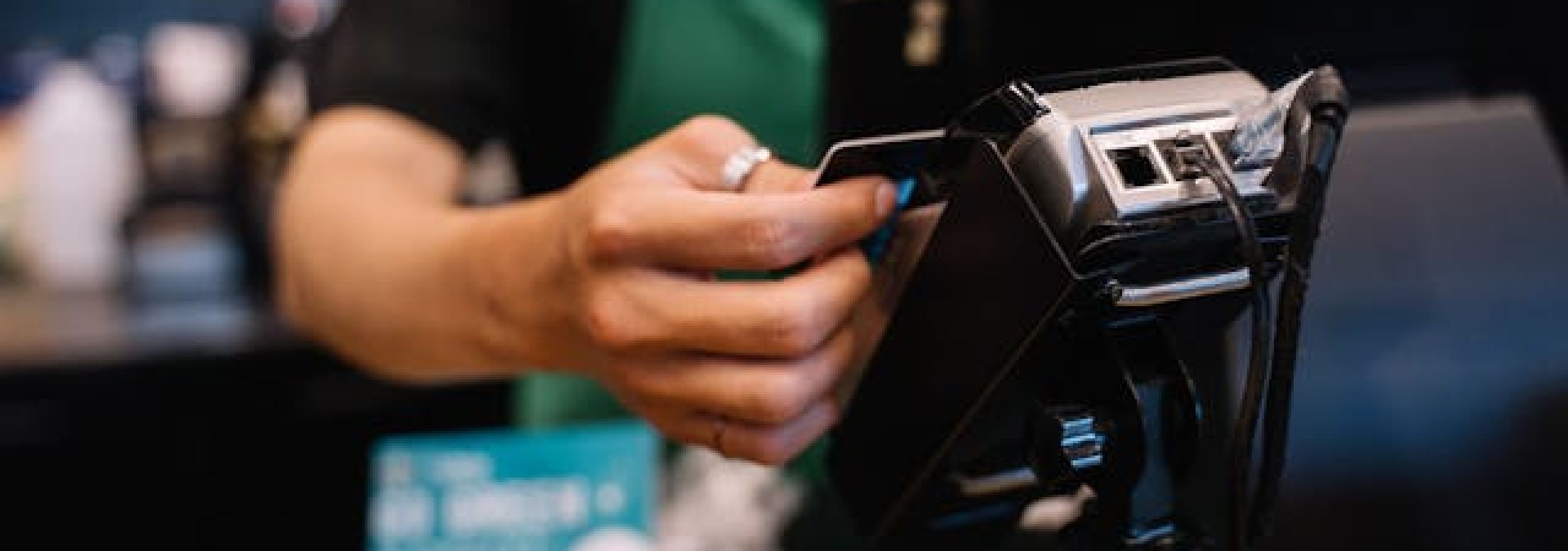 An employee uses a credit card machine
