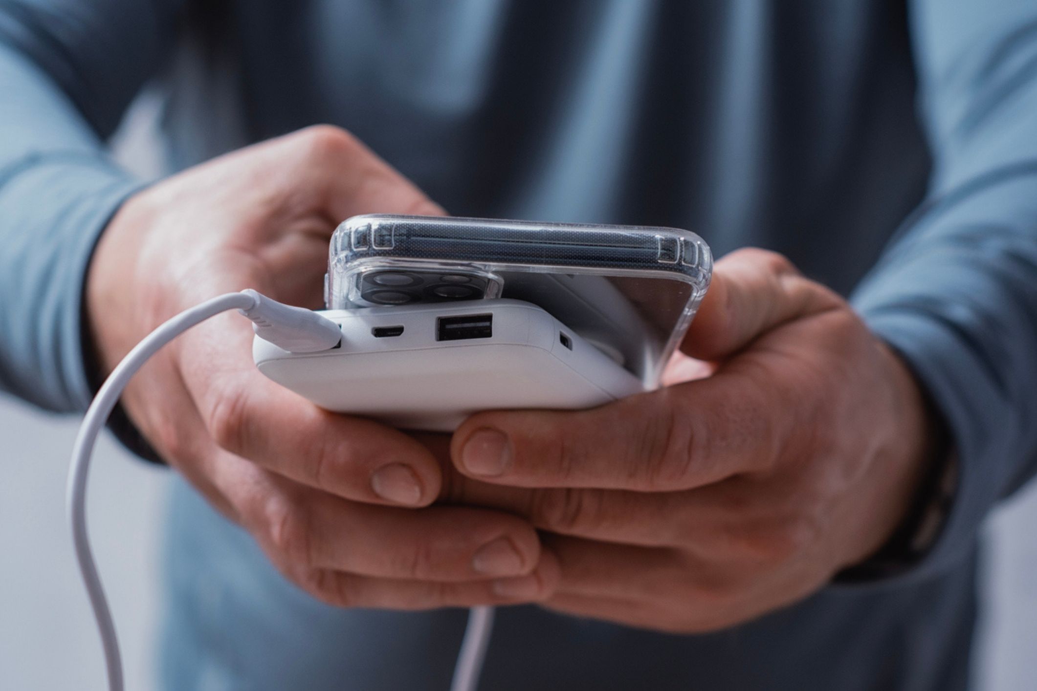 A man holding a power bank, one of the main devices prone to a lithium-ion battery explosion.