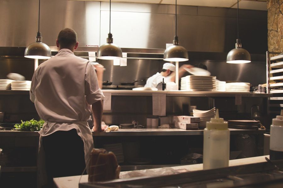 cooks preparing food in kitchen