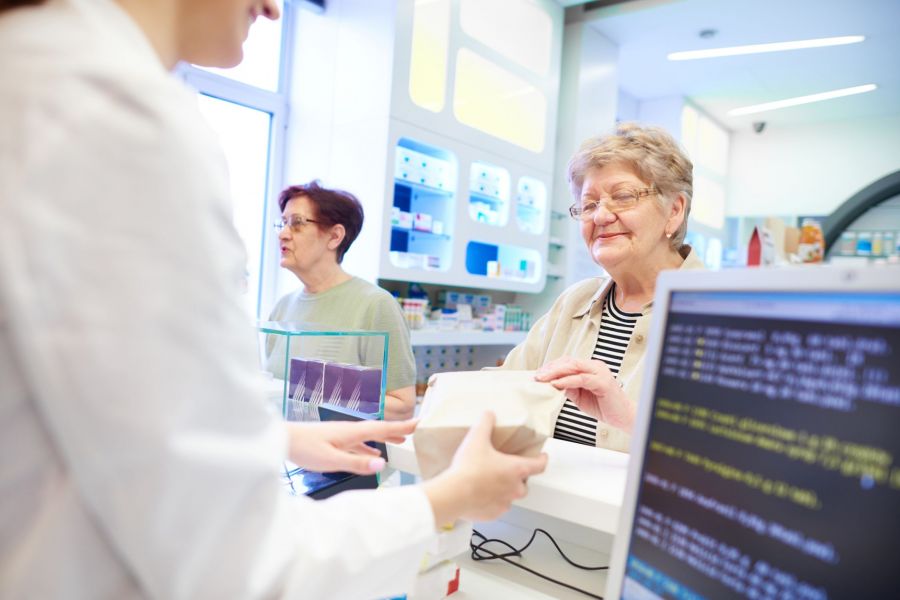 Woman looking at a medical form showcasing digital data exposure and the role of a HIPAA violation lawyer.