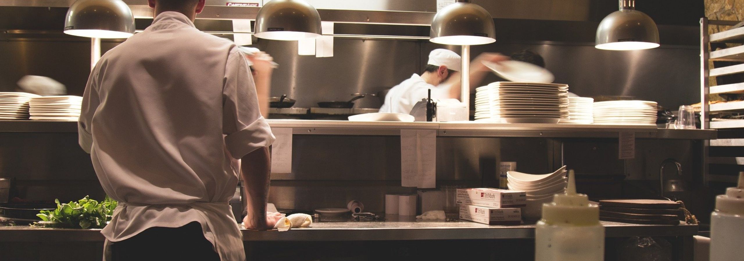 cooks preparing food in kitchen