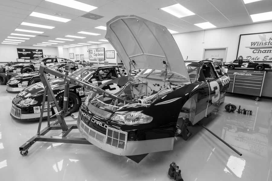 photo of nascar cars in the shop