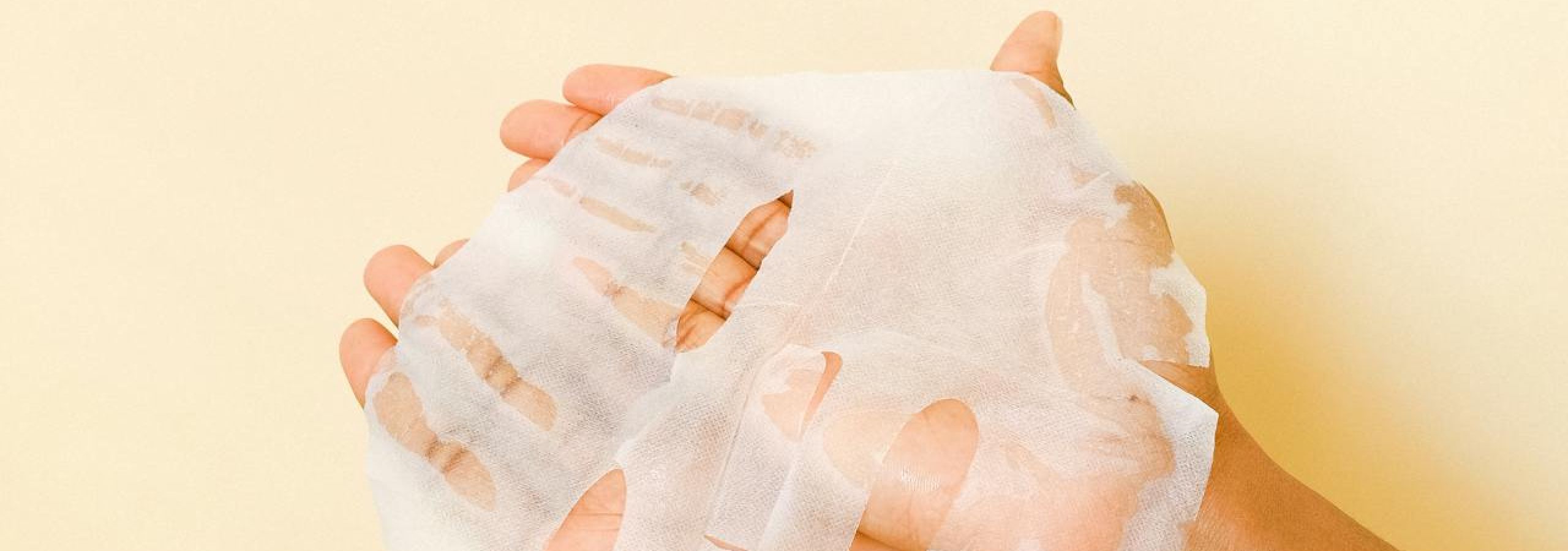 A woman holding a cosmetic beauty face mask in her hands