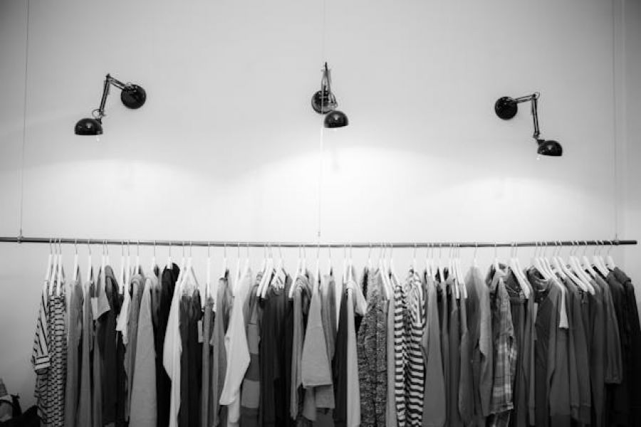 A rack of hanging clothing in a shop