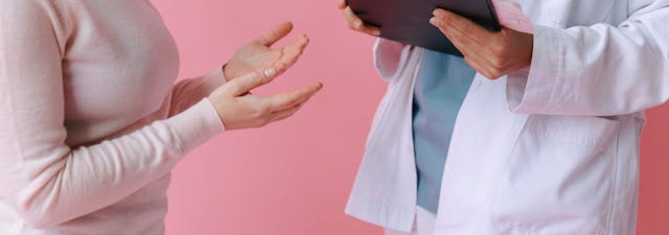 woman speaking to a doctor holding a tablet