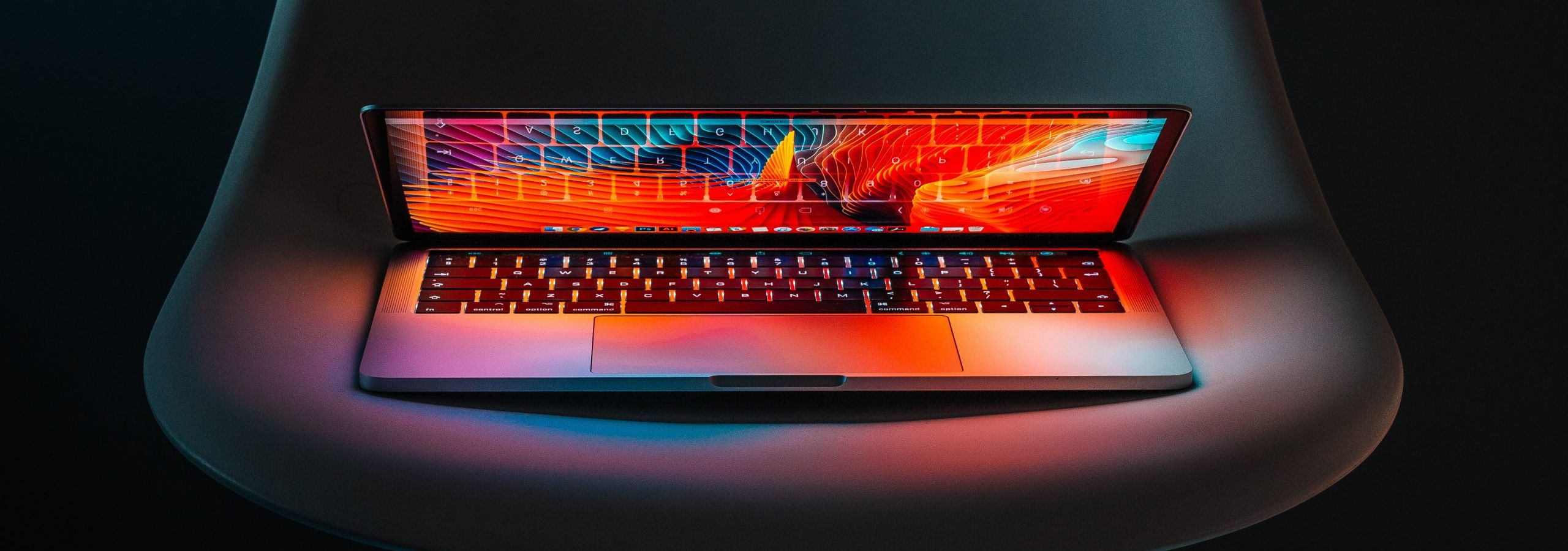 A laptop lit up with multiple colors A laptop lit up with multiple colors