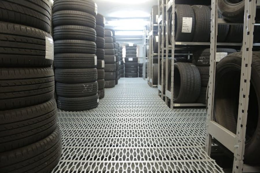 Car and truck tires stacked at a body shop