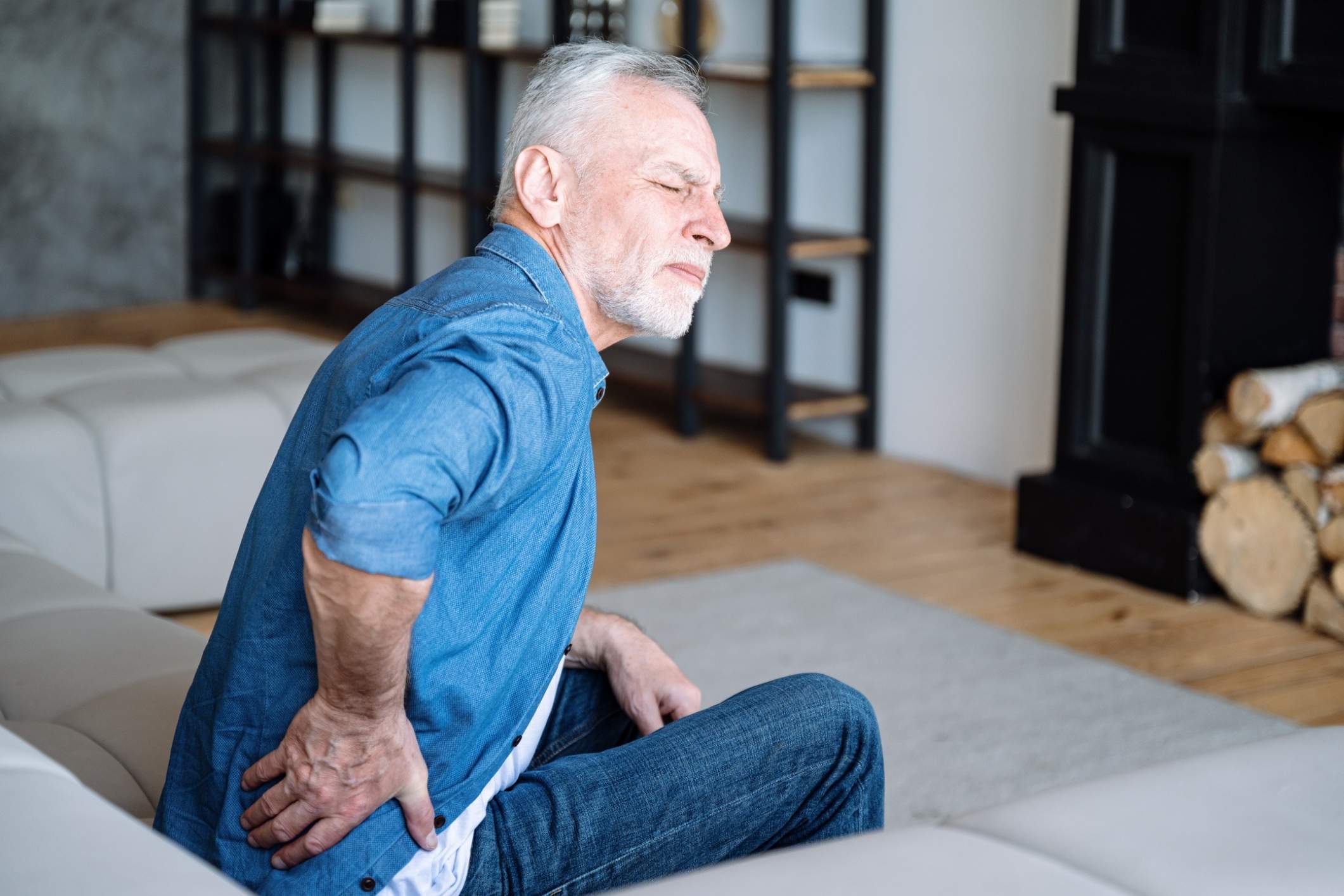 A man experiences severe back pain due to spinal cord stimulator problems.