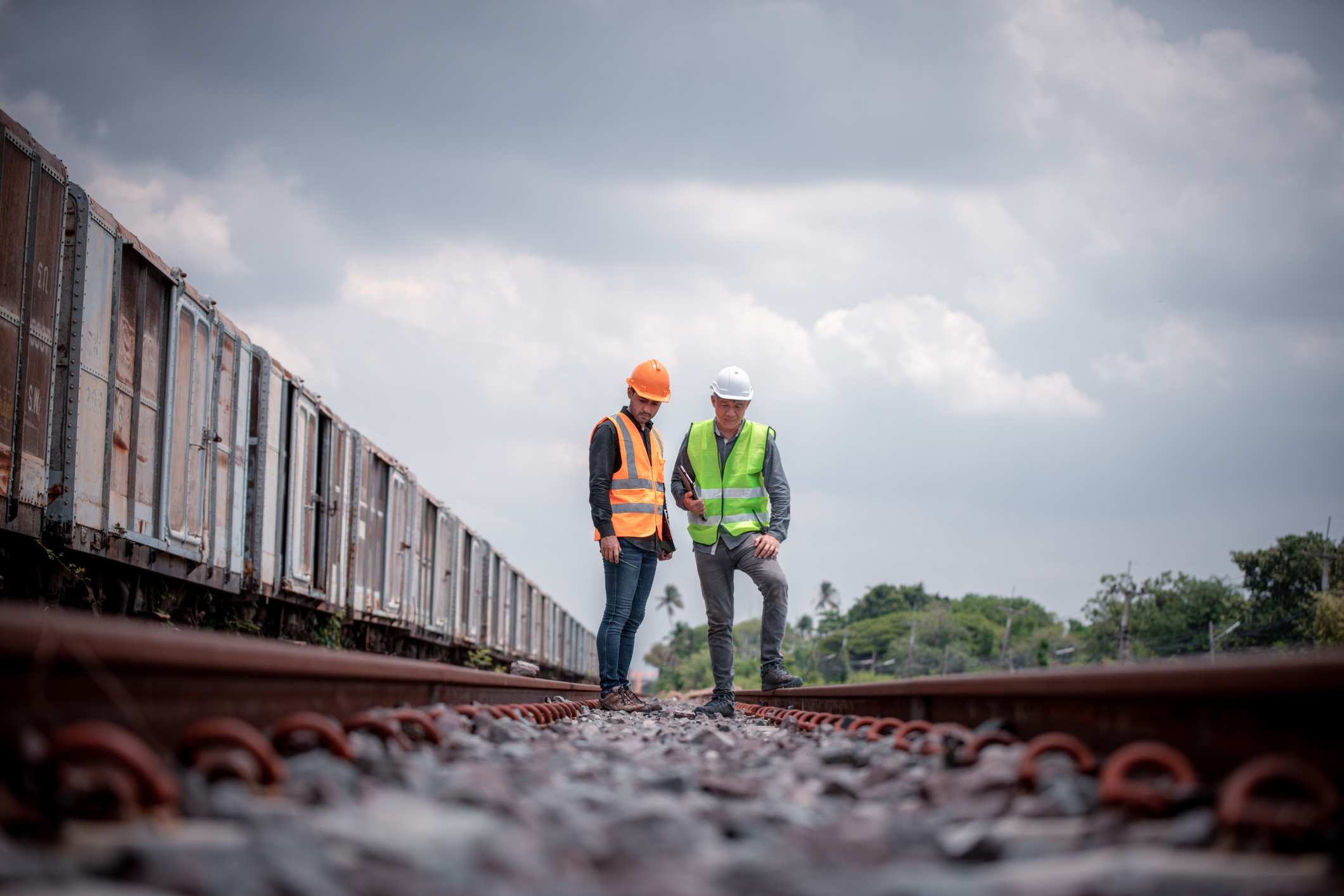Two railroad workers stand next to each other. They might be eligible for a FELA claim if they were injured at work.