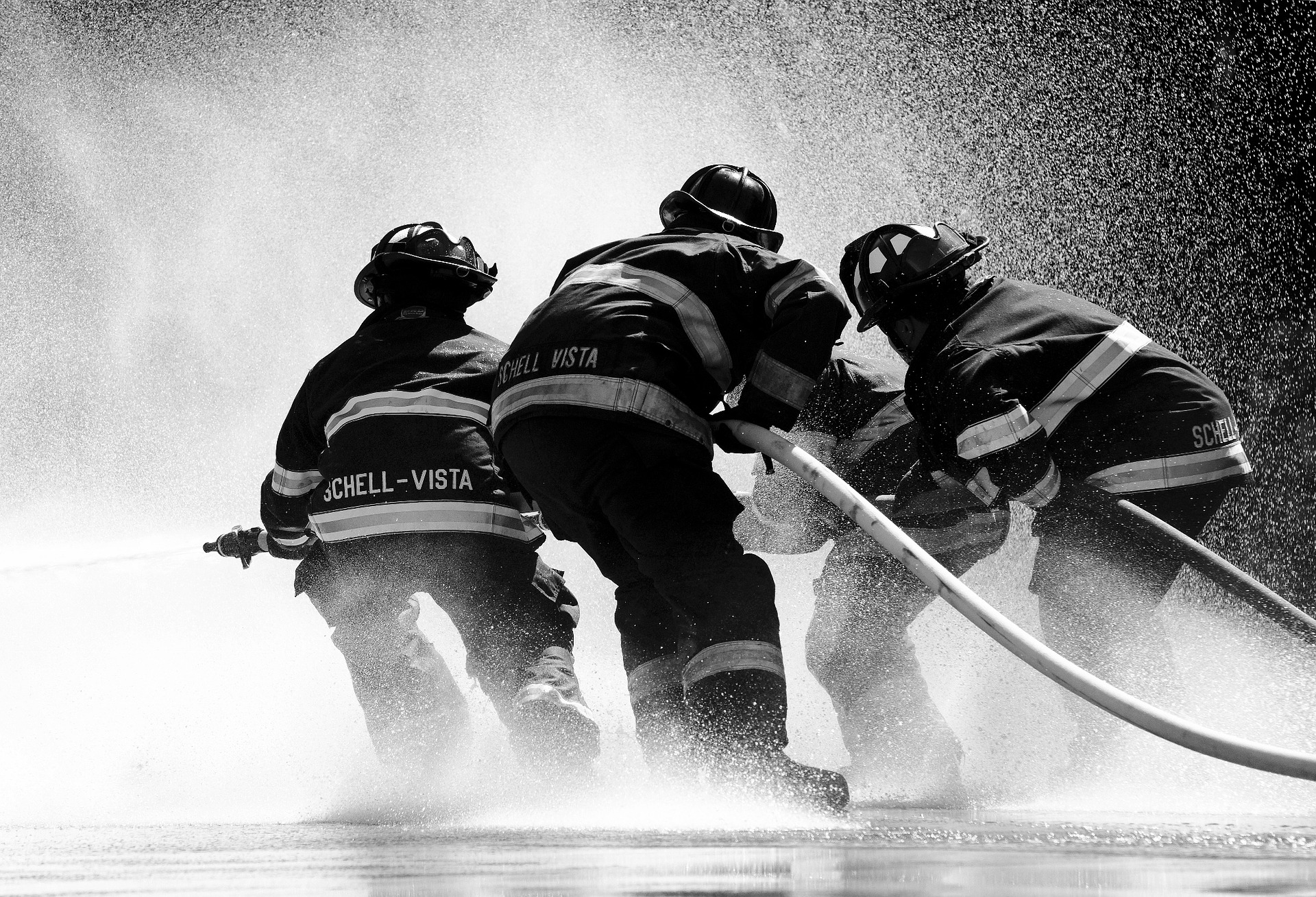 Firefighters using foam to fight blaze, linked to health risks and AFFF lawsuit claims.