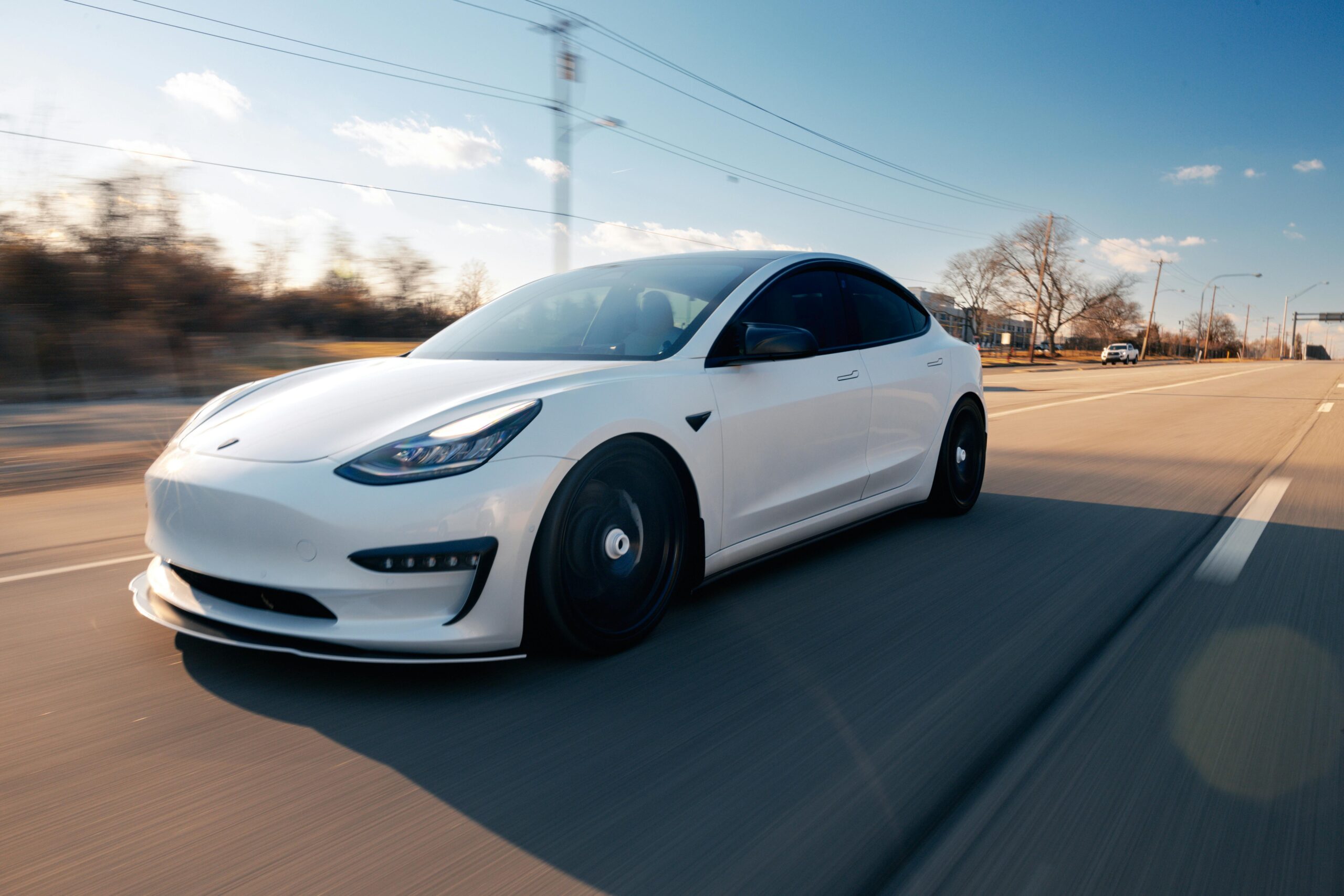 photo of a tesla on the road