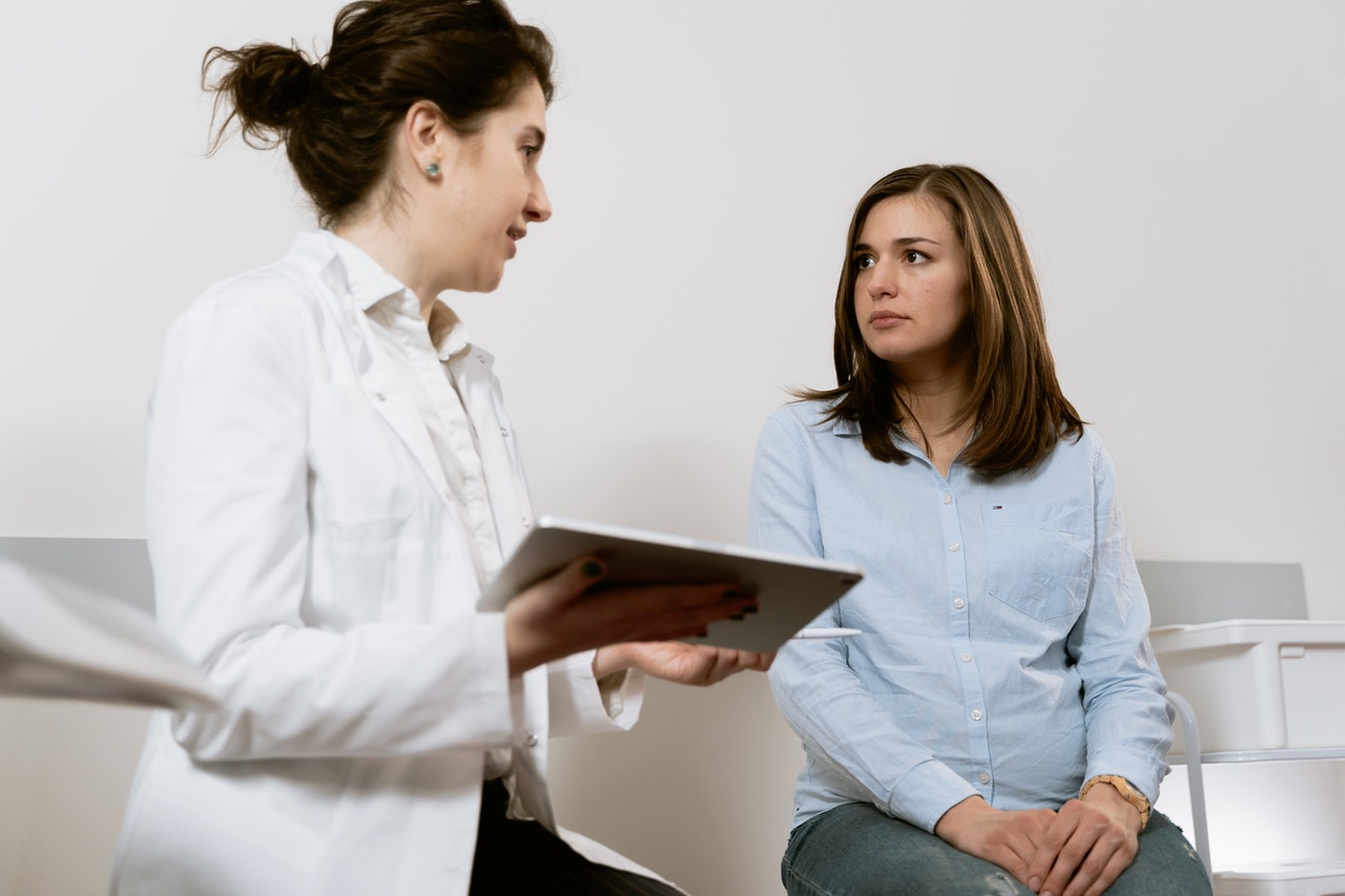 A doctor explaining a medical condition to her patient