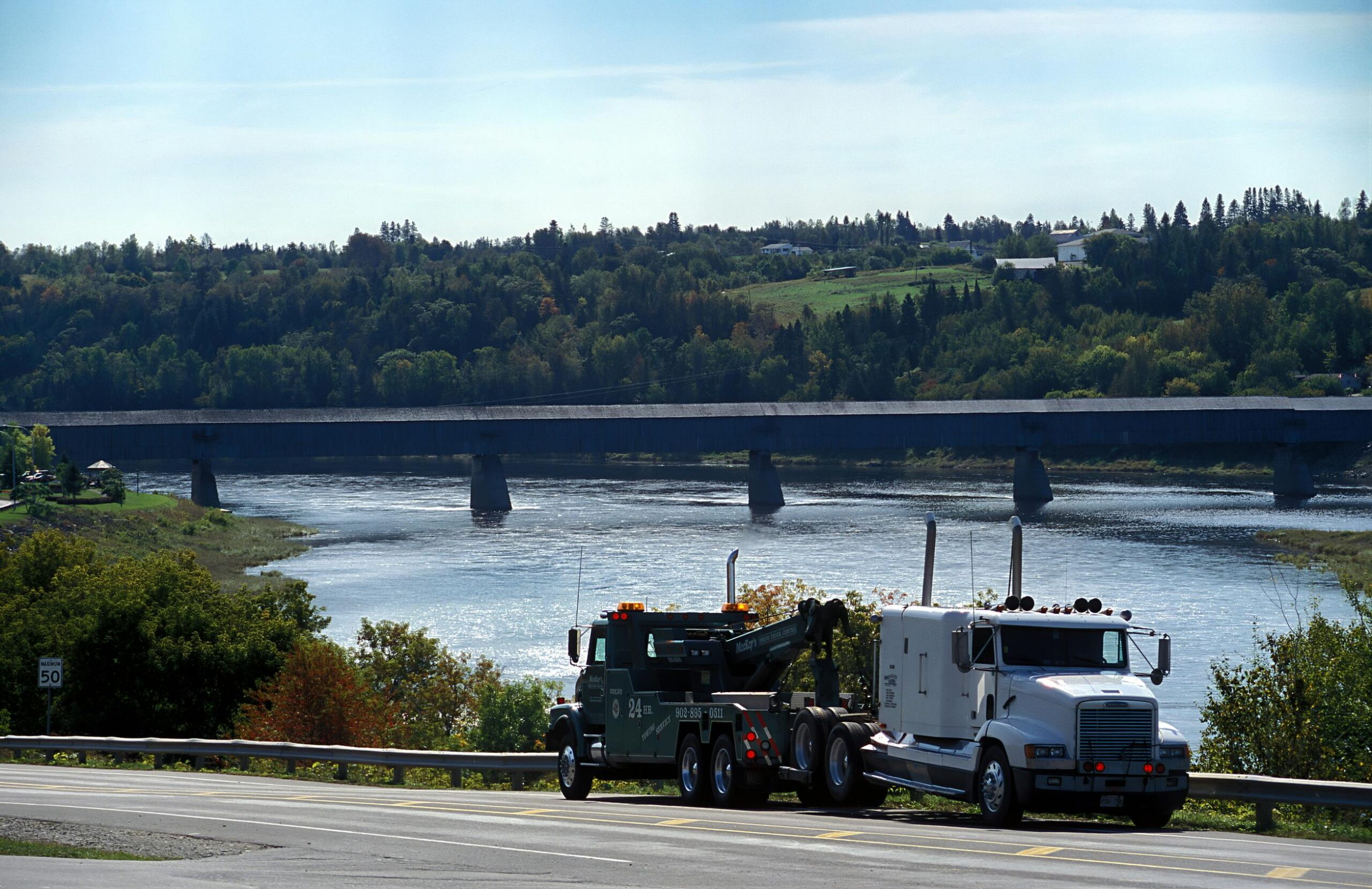 photo of a tow truck towing a semi